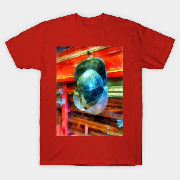 Helmet Hanging on Fire Truck T-Shirt by SusanSavad